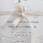 Wegner wedding - close up of precision cut pocket with ribbon tie - Bride and Groom's initials in design